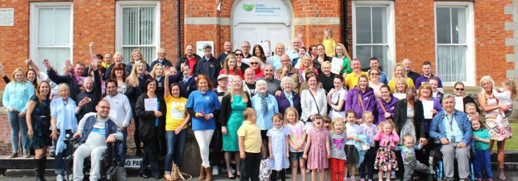 Employees line up outside Cloona House for a photograph