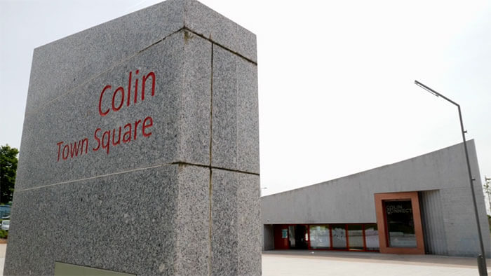 Photo showing Colin Connect transport hub and the town square sign